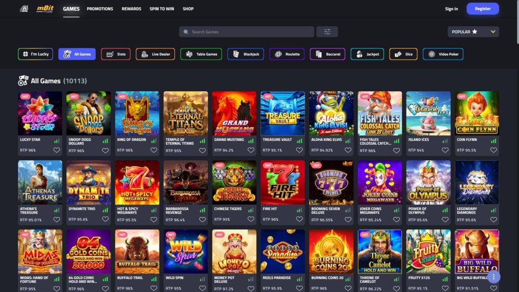 A high-definition screenshot of the mBit Casino "All Games" library, displaying over 10,000 online casino titles. The dark-themed interface features a top navigation bar with categories for Slots, Live Dealer, Table Games, Blackjack, Roulette, Baccarat, Jackpot, Dice, and Video Poker. The game grid showcases popular slot tiles such as Lucky Star, Snoop Dogg Dollars, King of Dragon, and Buffalo Trail, each indicating its specific RTP (Return to Player) percentage and "Hot" status. The layout includes a search bar, sorting options, and buttons for Promotions, Rewards, and Spin to Win