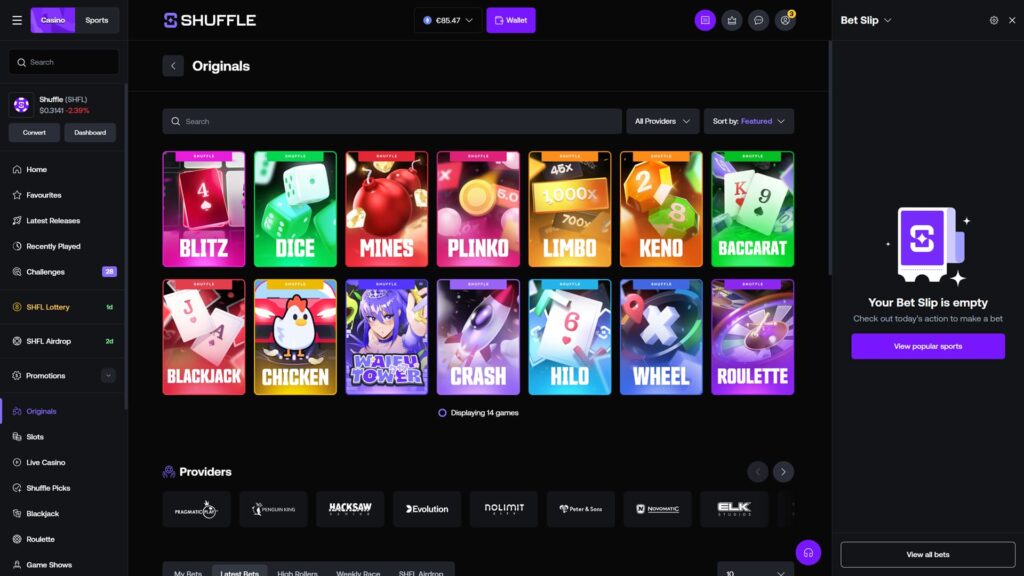 Shuffle casino Originals game lobby displaying 14 proprietary games in a dark-themed grid layout, including Blitz, Dice, Mines, Plinko, Limbo, Keno, Baccarat, Blackjack, Chicken, Waifu Tower, Crash, HiLo, Wheel, and Roulette, with a wallet balance of €85.47, an empty Bet Slip panel on the right, and a Providers row featuring Pragmatic Play, Penguin King, Hacksaw Gaming, Evolution, Nolimit City, Peter and Sons, Novomatic, and ELK Studios