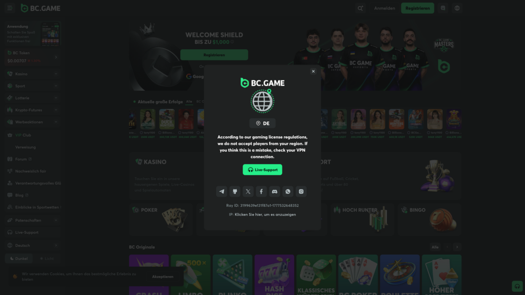 A high-definition screenshot of a geo-restriction modal on the BC.GAME crypto casino website. The dark-themed pop-up displays a globe icon and the country code "DE", stating that according to gaming license regulations, players from this region are not accepted. The message suggests checking a VPN connection if the block is a mistake. A green Live-Support button is visible, along with social media icons for Telegram, Discord, X, and Instagram. The blurred background shows the German-language version of the site, featuring a "Welcome Shield" bonus up to $1,000, the BC Game Esports team, and a carousel of current big wins