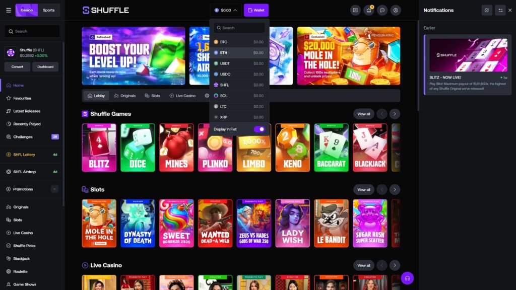 Shuffle.com online crypto casino homepage displaying the multi-currency wallet dropdown menu actively expanded in the top header, listing eight supported cryptocurrencies all showing zero balance — Bitcoin (BTC), Ethereum (ETH), Tether (USDT), USD Coin (USDC), Shuffle's native SHFL token, Solana (SOL), Litecoin (LTC) and Ripple (XRP) — with an integrated currency search bar and a 'Display in Fiat' toggle activated in purple at the bottom of the dropdown, partially visible promotional banner carousel behind the dropdown showing the Refreshed 'Boost Your Level Up' VIP rewards promo, an SHFL Airdrop announcement, and an Exclusive '$20,000 Mole in the Hole' Penguin King slot promotion offering 100x multipliers, Shuffle Games tile carousel below featuring Blitz, Dice, Mines, Plinko, Limbo, Keno, Baccarat and Blackjack original games, Slots row showing Mole in the Hole (Penguin King), Dynasty of Death (Hacksaw), Sweet Bonanza 2500 (Pragmatic Play), Wanted Dead or A Wild (Hacksaw), Zeus vs Hades Gods of War 250 (Pragmatic Play), Lady Wish (Penguin King), Le Bandit (Hacksaw) and Sugar Rush Super Scatter (Pragmatic Play), beginning of a Live Casino section, full sidebar navigation including Home (active), Favourites, Latest Releases, Recently Played, Challenges (28), SHFL Lottery (4d), SHFL Airdrop (4d), Promotions, Originals, Slots, Live Casino, Shuffle Picks, Blackjack, Roulette and Game Shows, right-side Notifications panel showing 'BLITZ — NOW LIVE!' announcement with Shuffle's record 15,181,603x maximum payout dated 1 week ago, $0.2892 SHFL token ticker (+0.00%), and Convert/Dashboard wallet management buttons