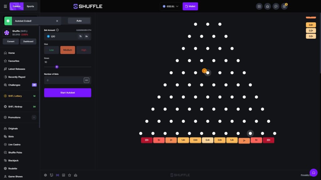Shuffle casino Plinko game on the Auto tab with a green banner at the top reading 'Autobet Ended!', a €1.00 bet amount, Medium risk, 10 rows, and a Number of Bets field set to 0 with a Start Autobet button, showing an orange ball actively mid-drop through the peg board roughly halfway down, a dark ball visible near the bottom row close to the 2x bucket, and the multiplier row at the bottom ranging from 22x on the outer edges to 0.4x in the center, with three recent multiplier results (0.6x, 0.3x, 0.5x) visible in the top right corner